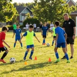 Youth soccer players training at mequonsoccerclub.com under a coach's guidance, vibrant uniforms and dynamic drills.
